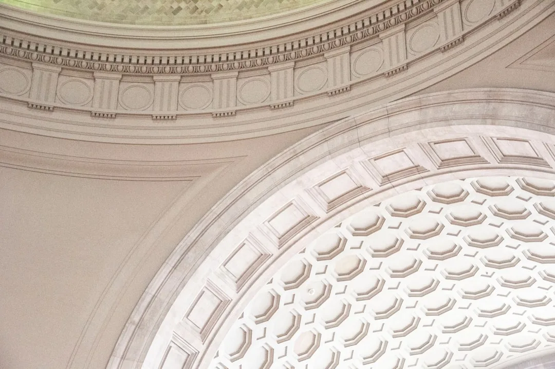 the ceiling of a building with a clock on it