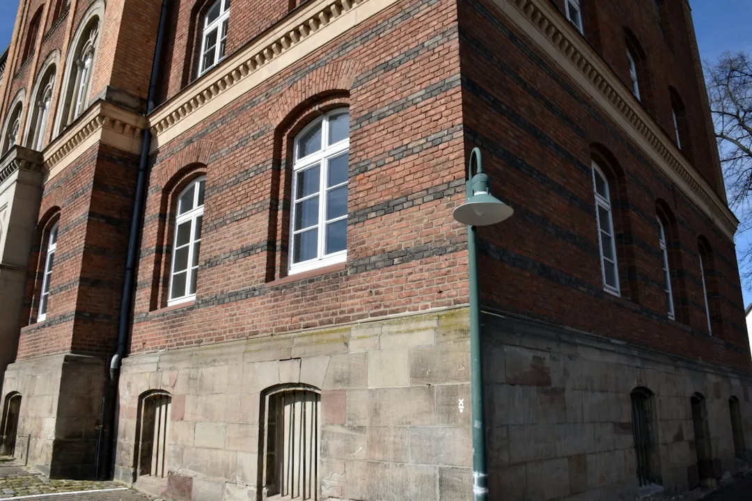 Corner of a brick building with arched windows