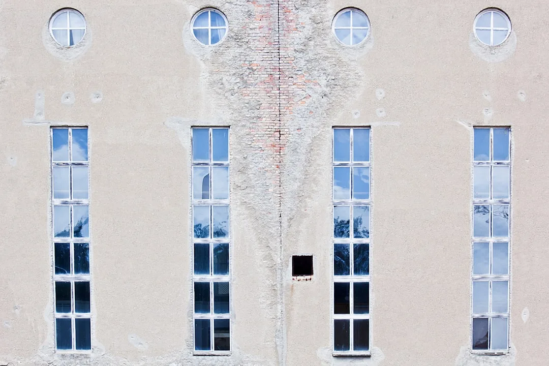 A white building with four windows and a clock