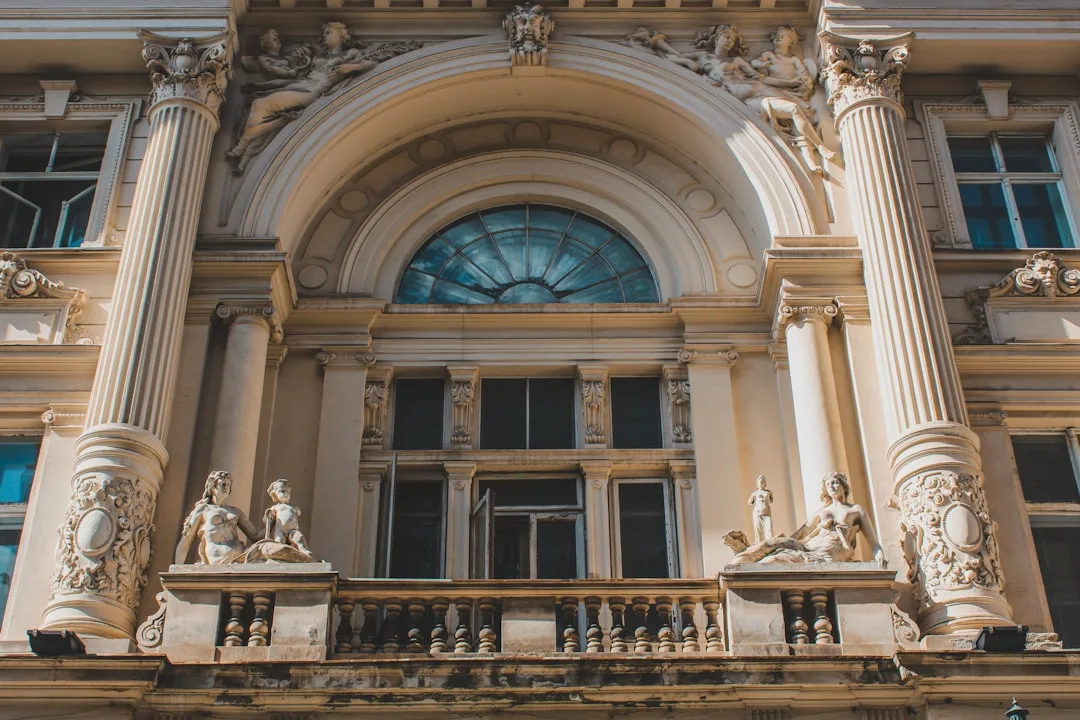 a large building with statues on the balconies