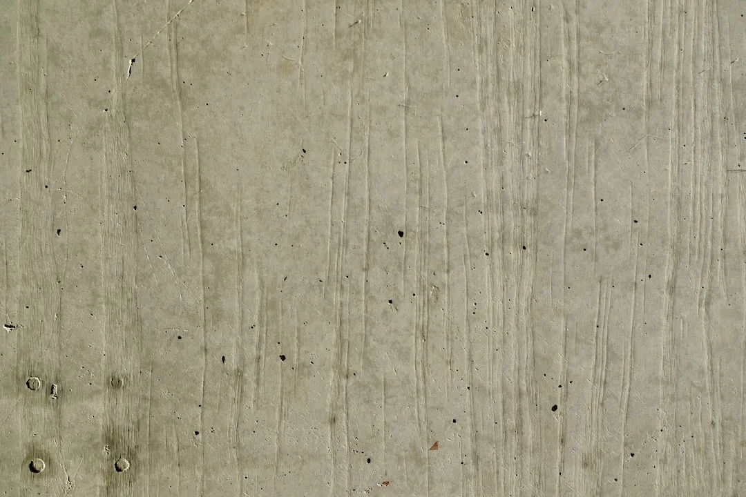 A textured concrete wall with vertical lines.