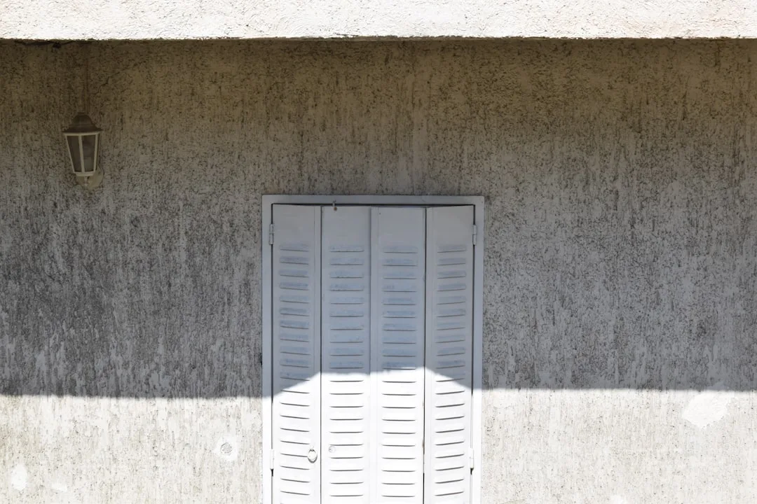a shadow of a person standing in front of a building