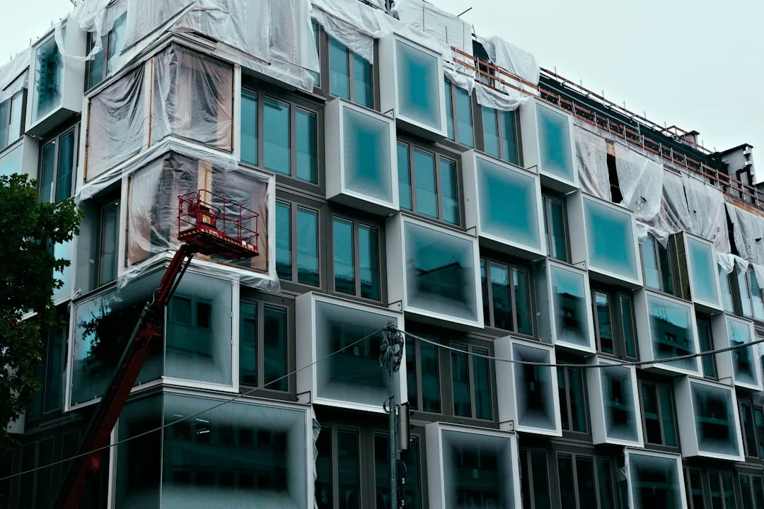 Modern building under construction with unique window design.