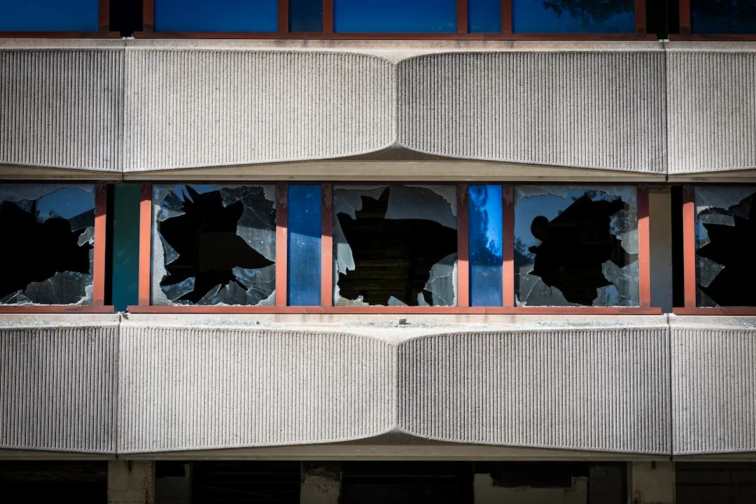 Broken windows on a concrete building facade.