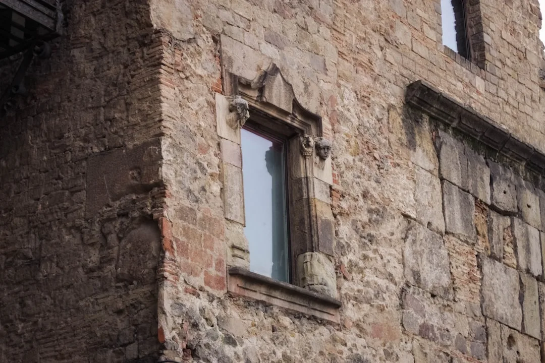 Detail of an old stone building with a window.