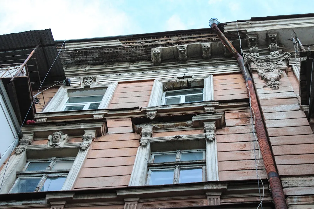 a tall building with lots of windows next to a street