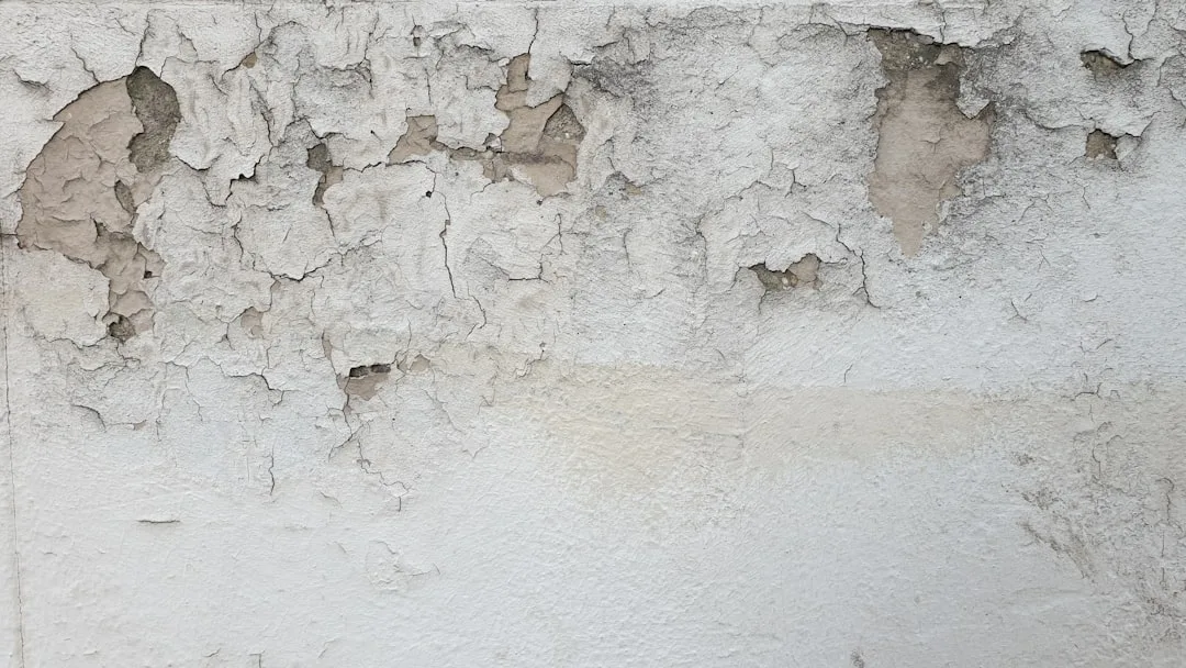 a white wall with peeling paint on it