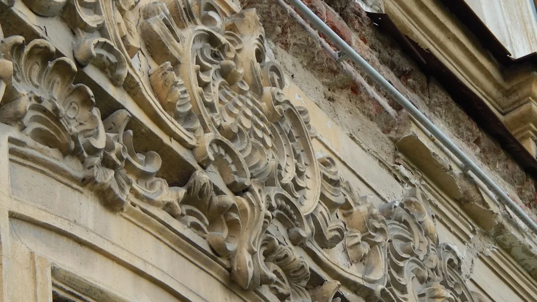 Intricate stone carvings adorn old building facade