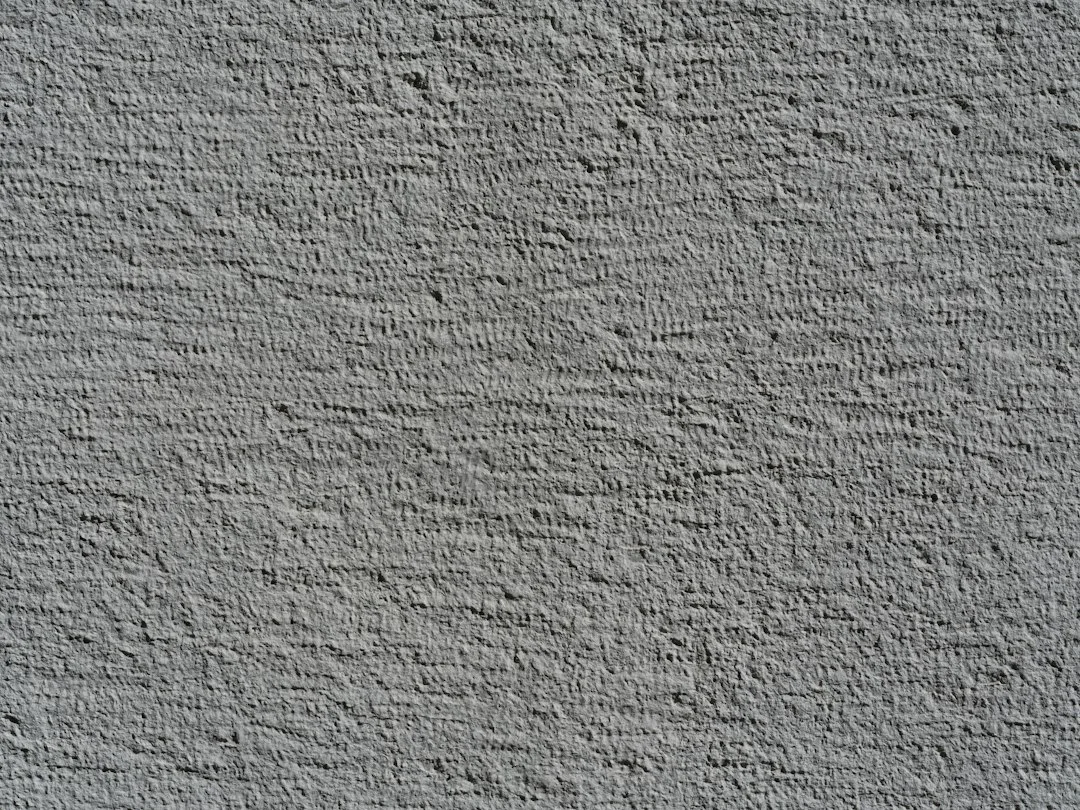 Rough textured gray wall surface with shadows