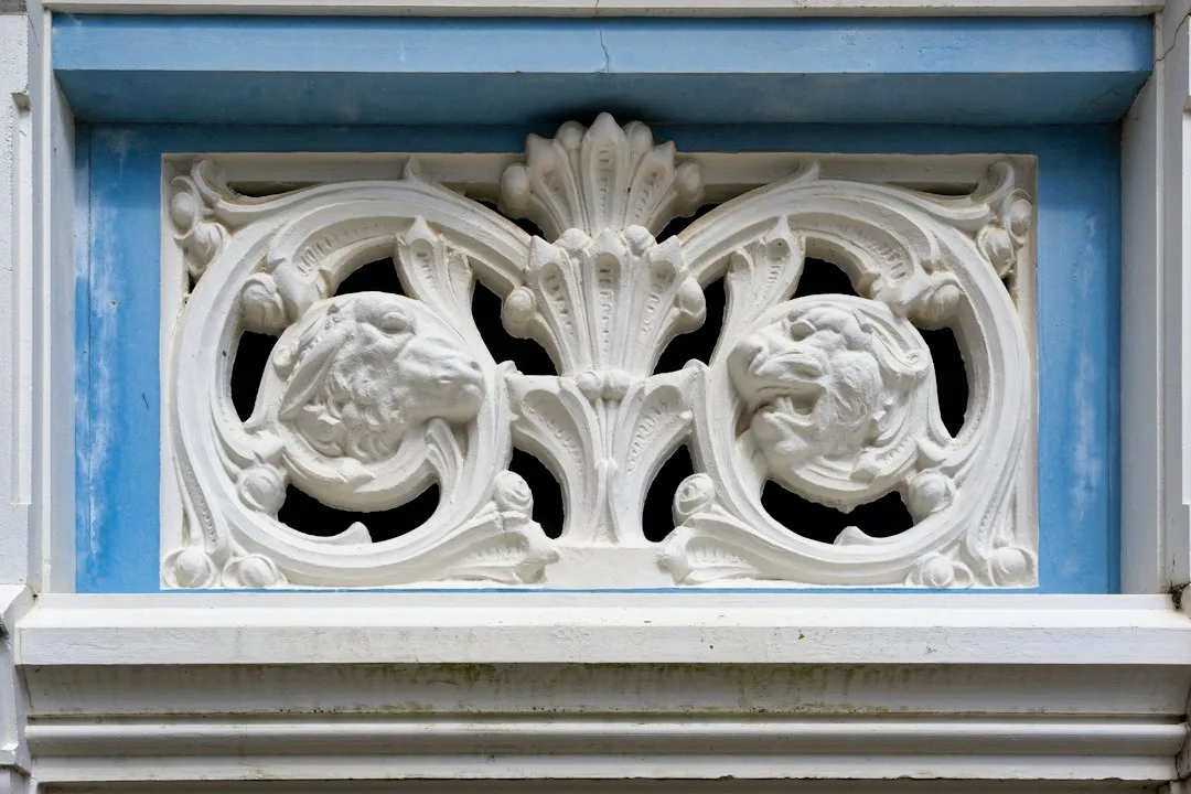 Ornate, white architectural detail set in blue